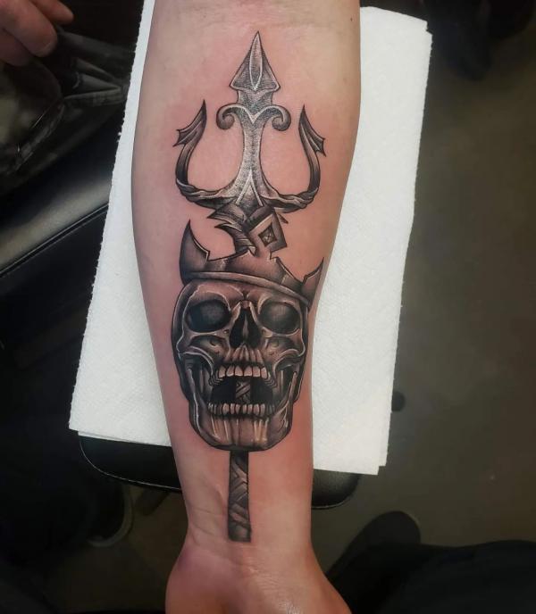 Trident and skull forearm tattoo
