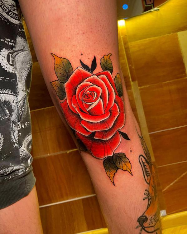 Vibrant red rose tattoo