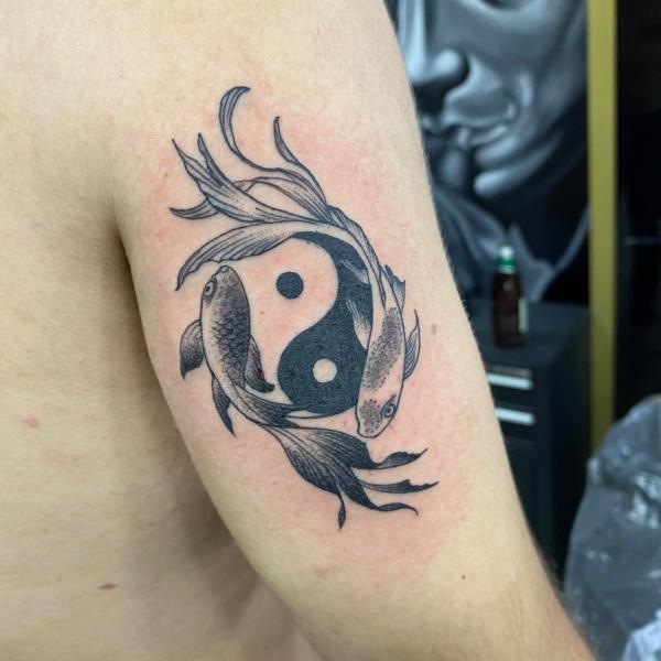 Yin Yang koi fish arm tattoo