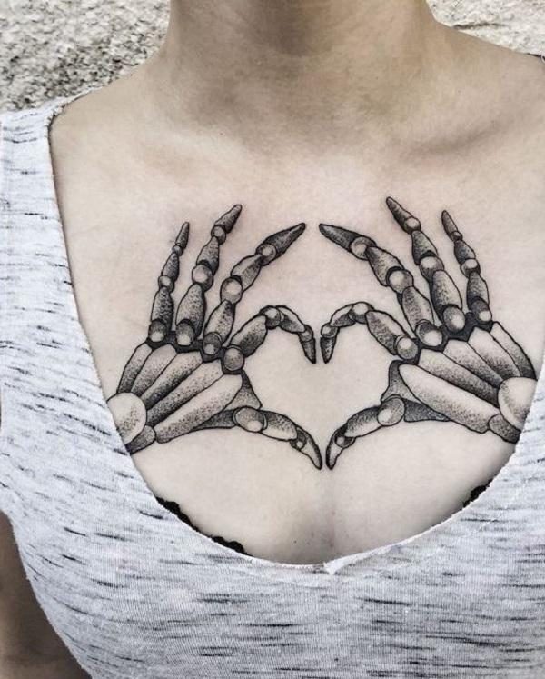 skeleton hand holding heart tattoo