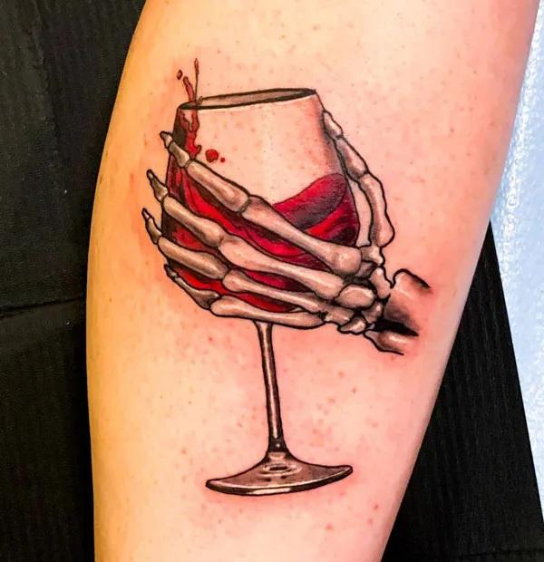 skeleton hand holding wine glass tattoo