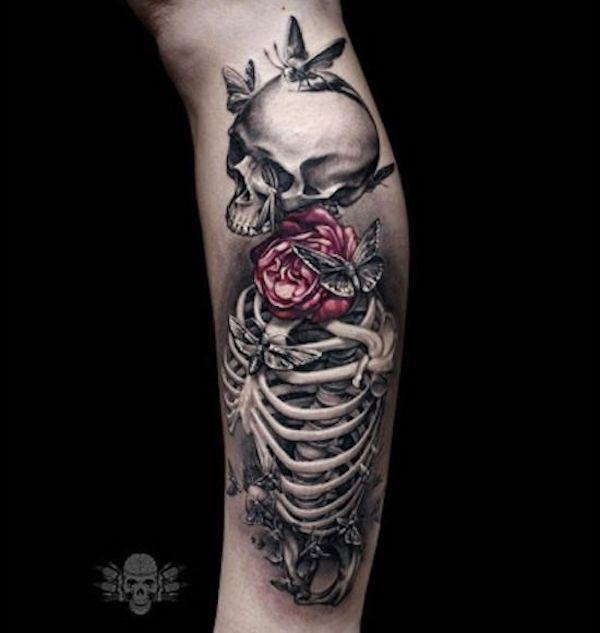 3D skeleton with rose and butterfly lower leg tattoo