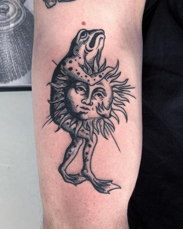 A frog holding a sun face