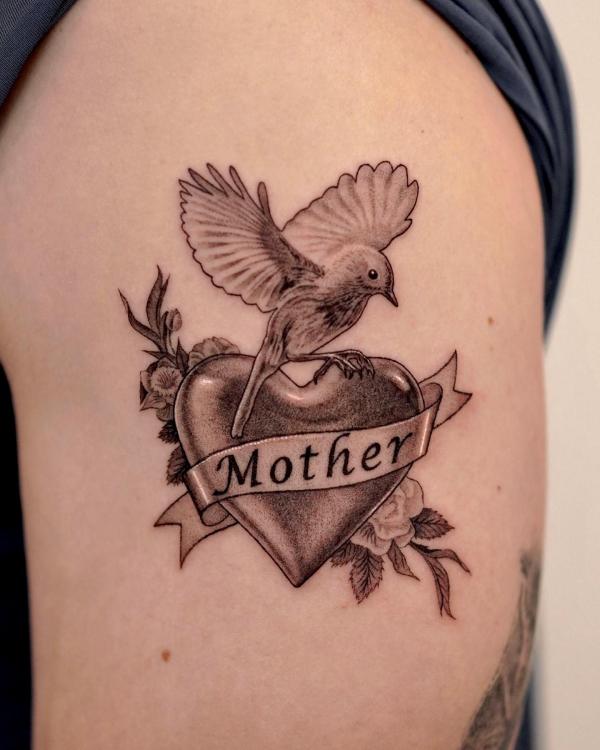 Bird perched on a heart symbol bearing the word Mother