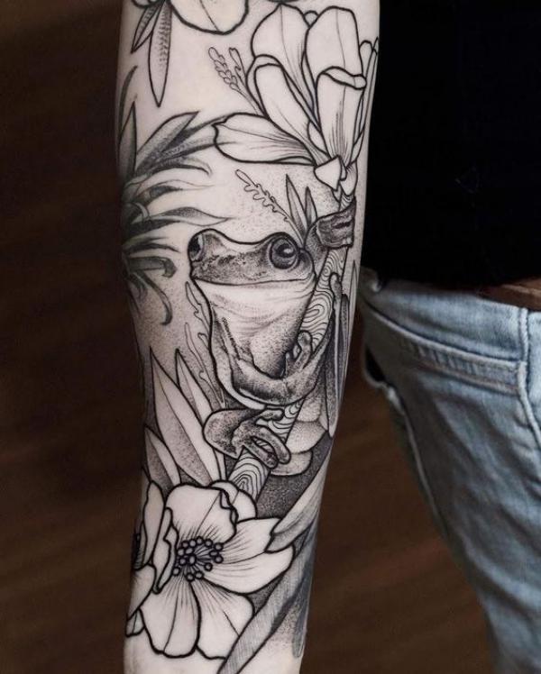 Black and white frog and flower drawing tattoo