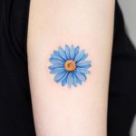 Blue daisy tattoo
