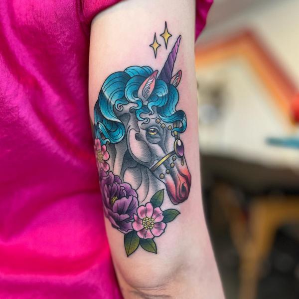 Colorful unicorn and flower tattoo