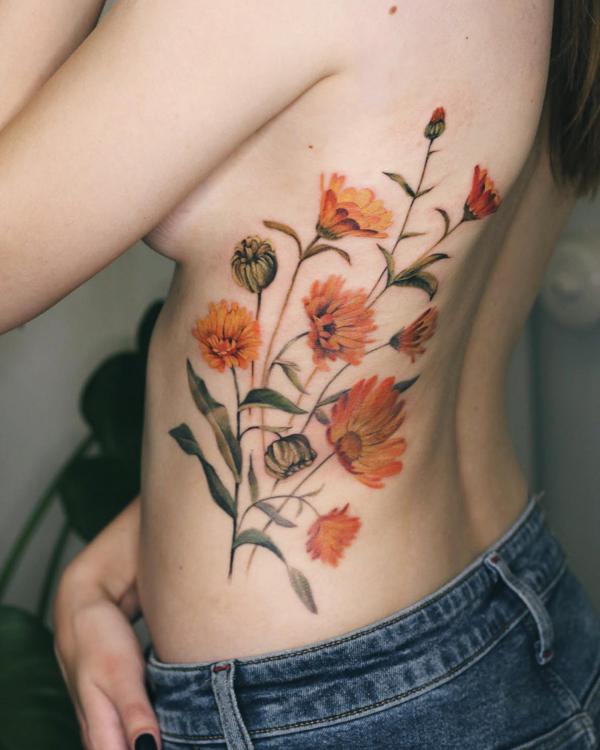 Daisy rib cage tattoo