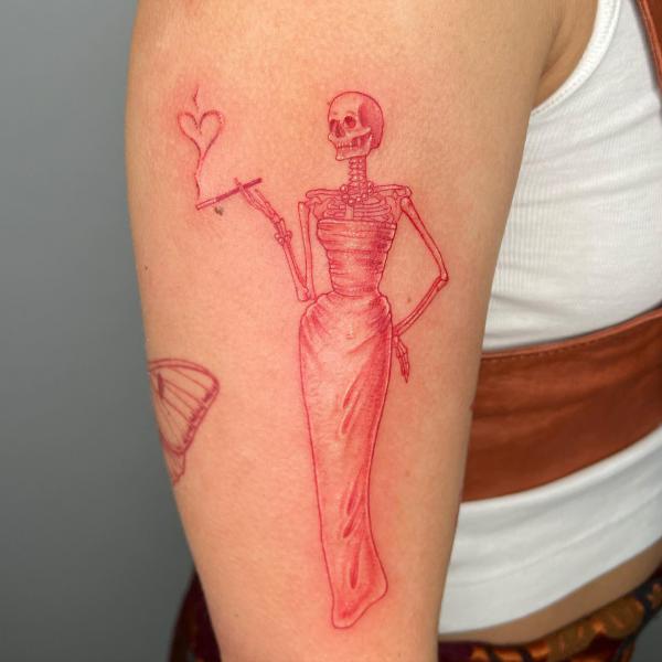 Female skeleton in skirt with a cigarette