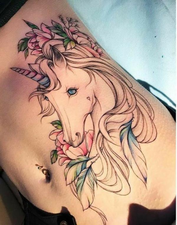 Fine line unicorn with flowers side tattoo