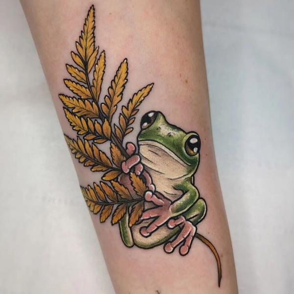 Frog holding fern