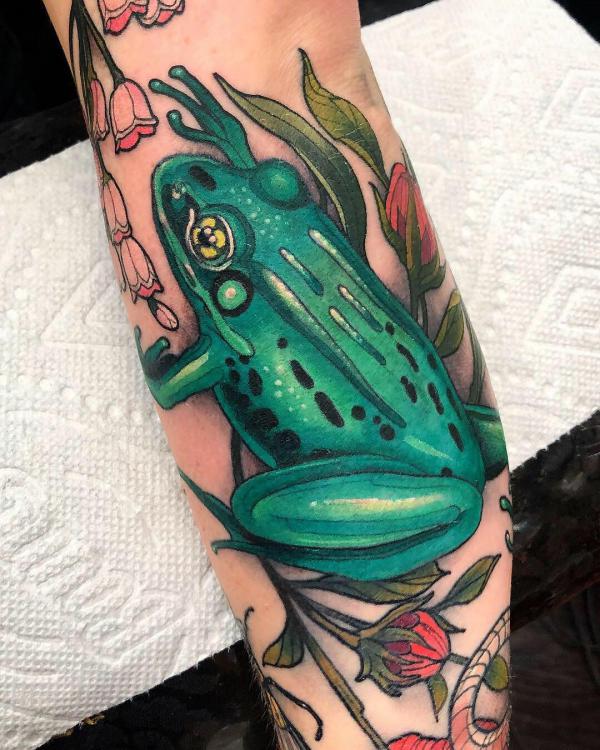 Traditional frog tattoo on the left forearm.