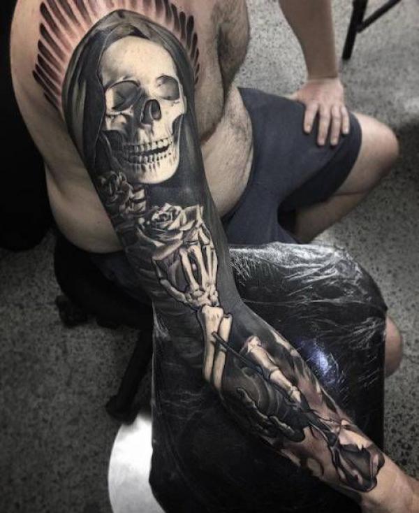 Grim reaper with skeleton hand holding roses