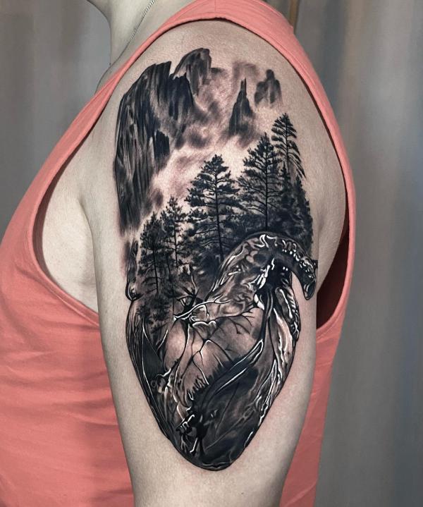 Human heart and mountain tattoo