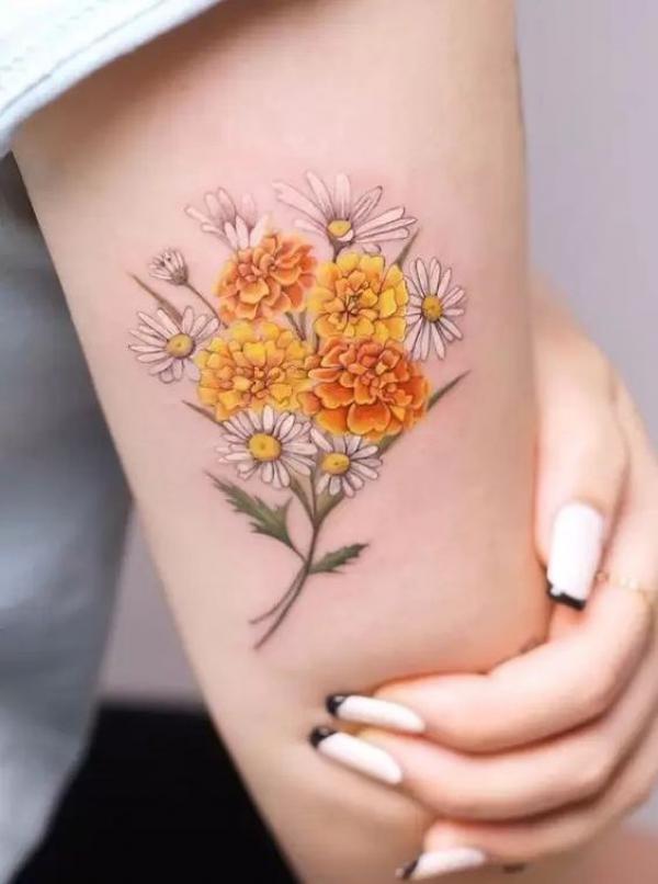 Marigold and daisy tattoo