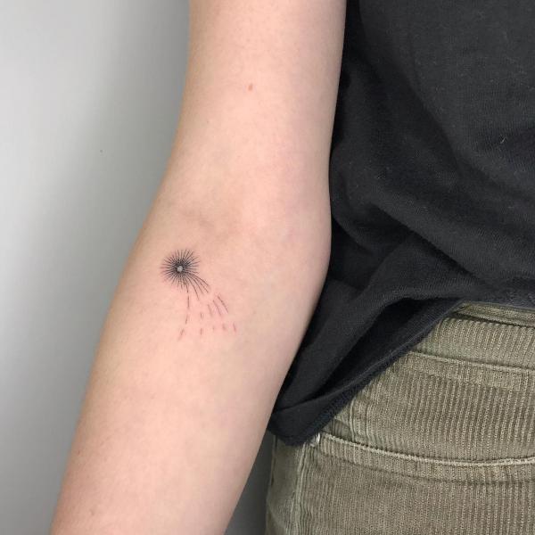 Minimalist shooting star tattoo