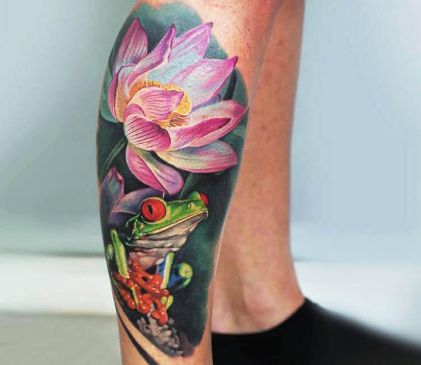 Realistic frog and lotus lower leg tattoo