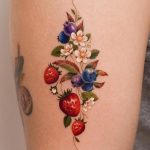 Realistic strawberry and blueberry tattoo