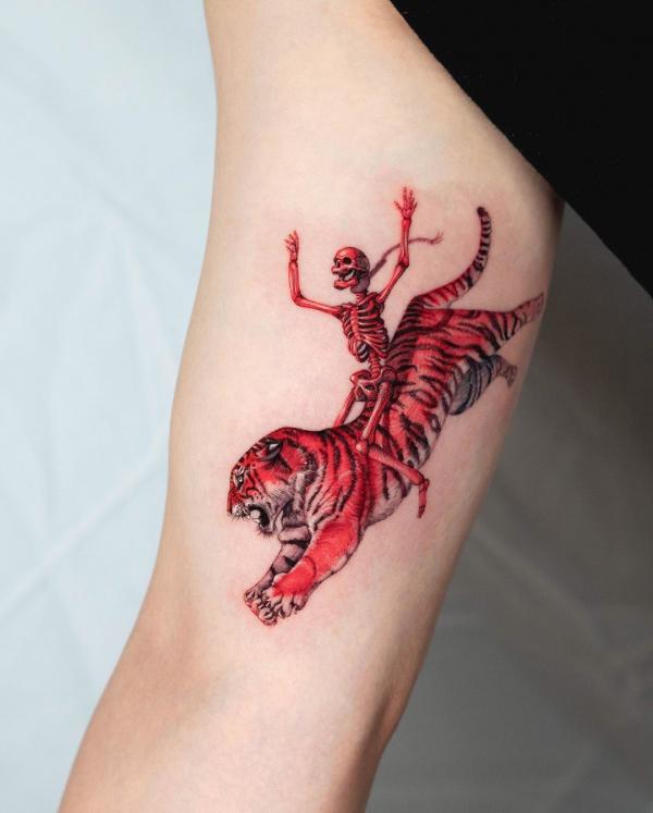 Red skeleton riding on a running tiger