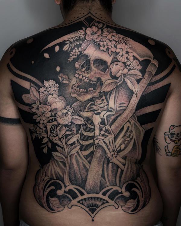 Skeleton carrying a scythe with flowers