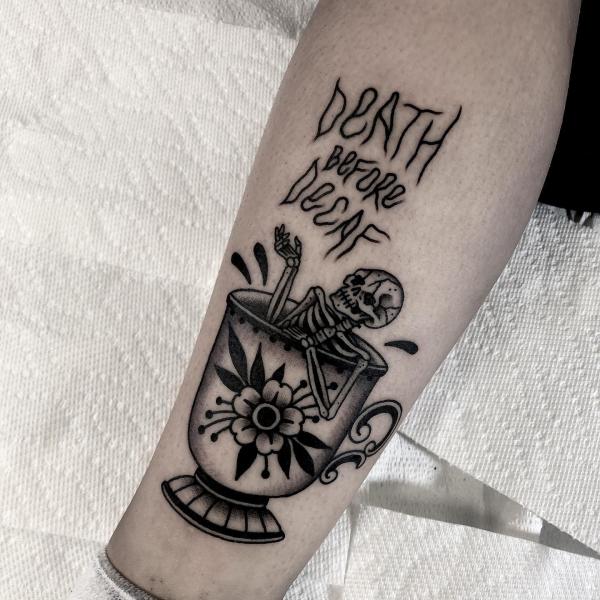 Skeleton in cup with worfd Death before decaf