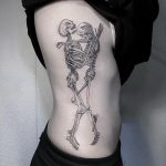 Two hugging skeletons side tattoo