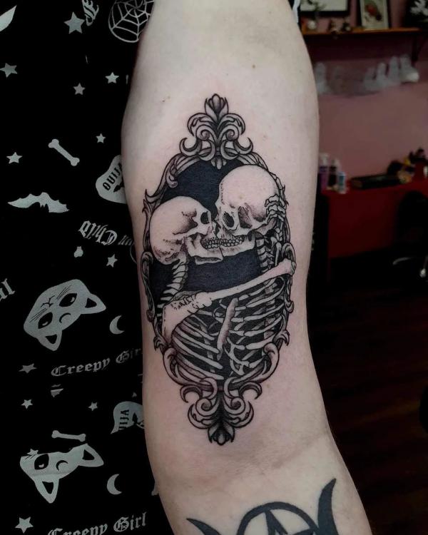 Two skeletons kissing in black frame
