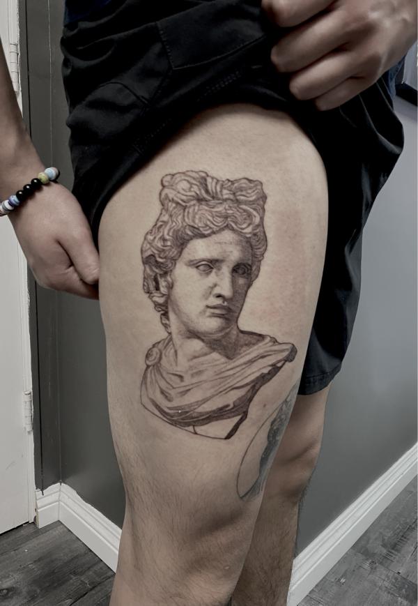 Apollo statue thigh tattoo