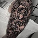 Athena holding a spear and Aegis shield on the background of Greek key