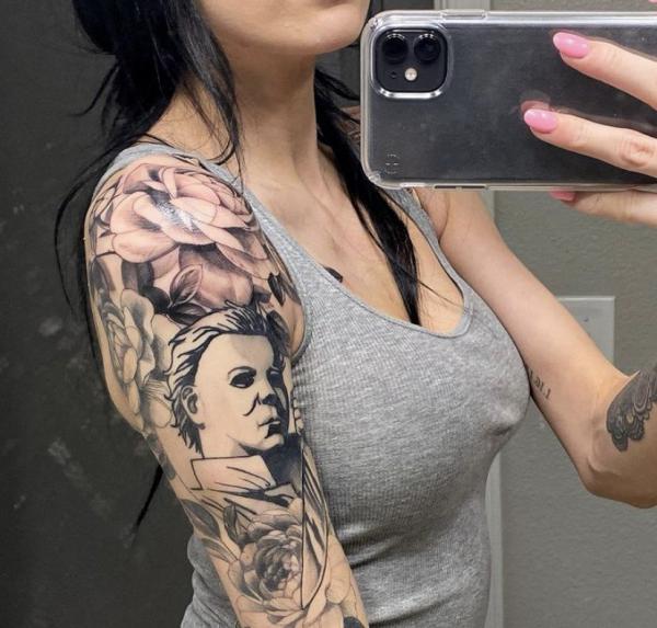 Black and grey Michael Myers and flower tattoo