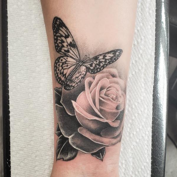 Black and grey rose and butterfly tattoo