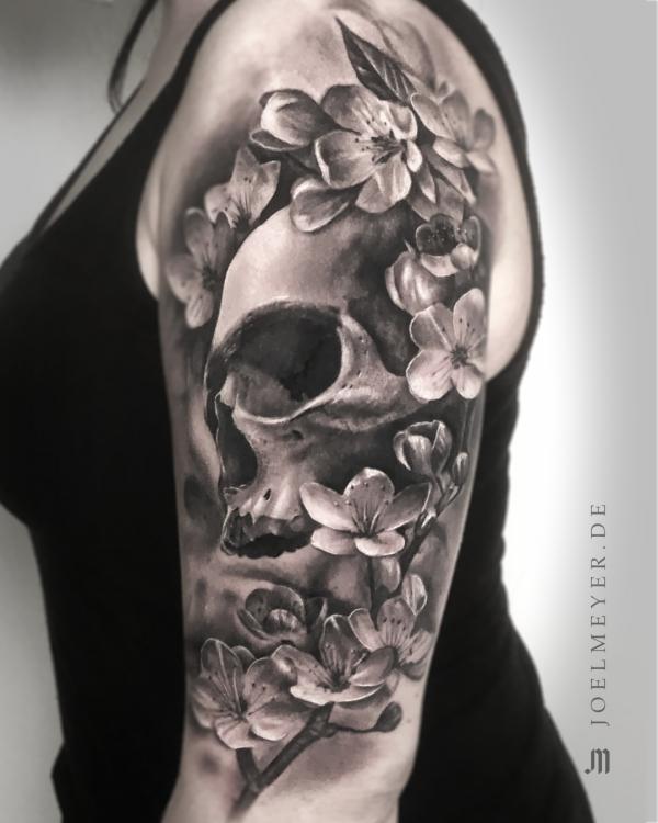 Black and grey skull with cherry blossom tattoo