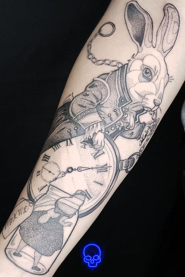 Black and grey white rabbit and clock arm tattoo