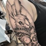 Black and grey white rabbit with clock and flower