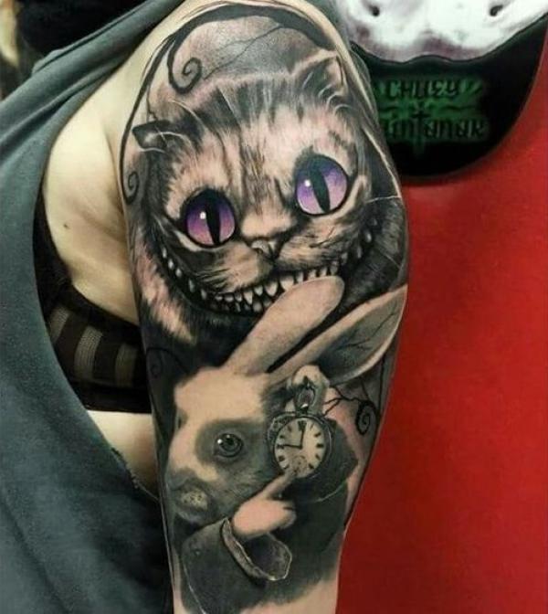 Black and white Cheshire Cat and white rabbit half sleeve tattoo