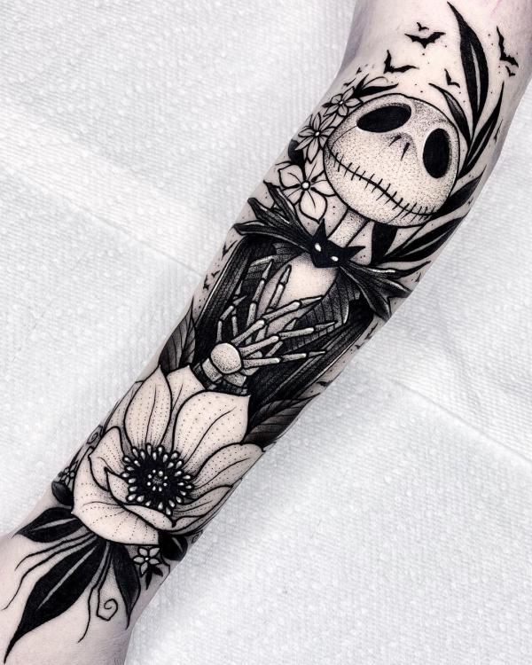 Black and white Jack Skellington and flower tattoo forearm