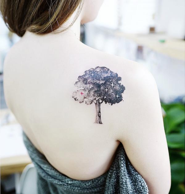 Black and white galaxy tree shoulder tattoo