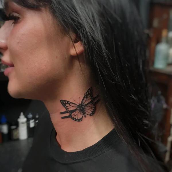 Black and white monarch butterfly side neck tattoo