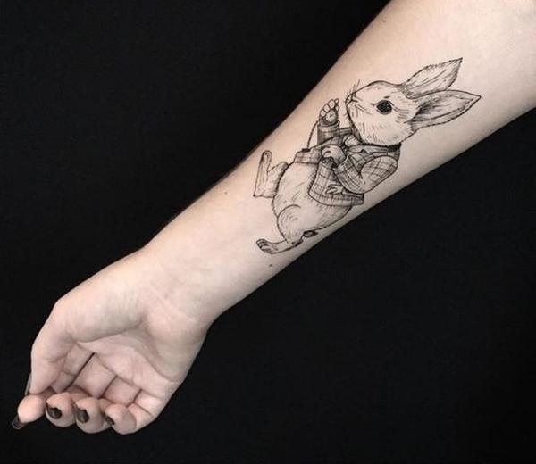 Black and grey white rabbit tattoo on forearm
