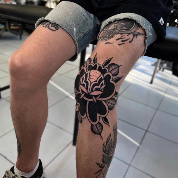 Black rose knee tattoo