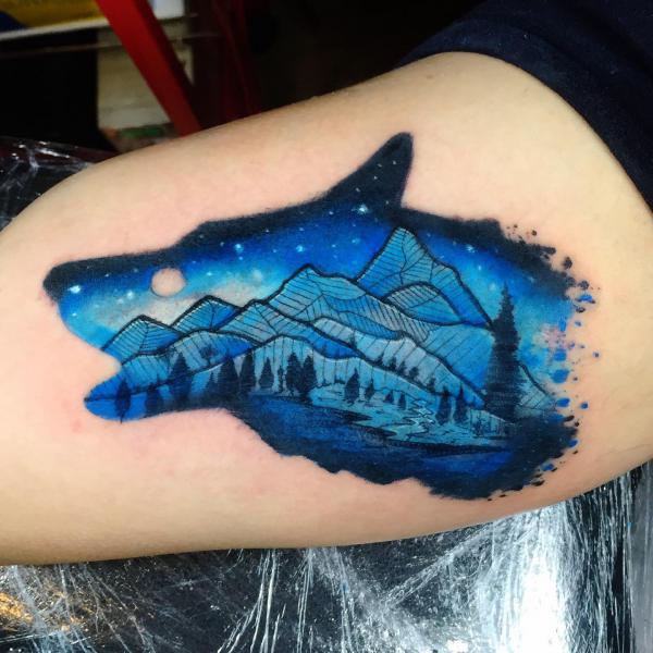 Blue galaxy and landscape wolf tattoo
