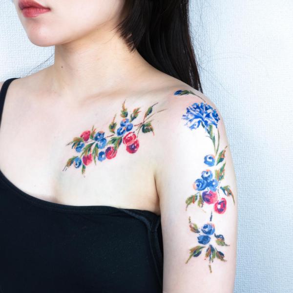 Blueberries cherries and blue carnations