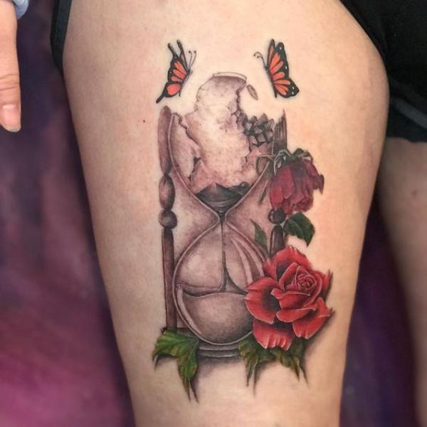Broken hourglass with rose and butterflies