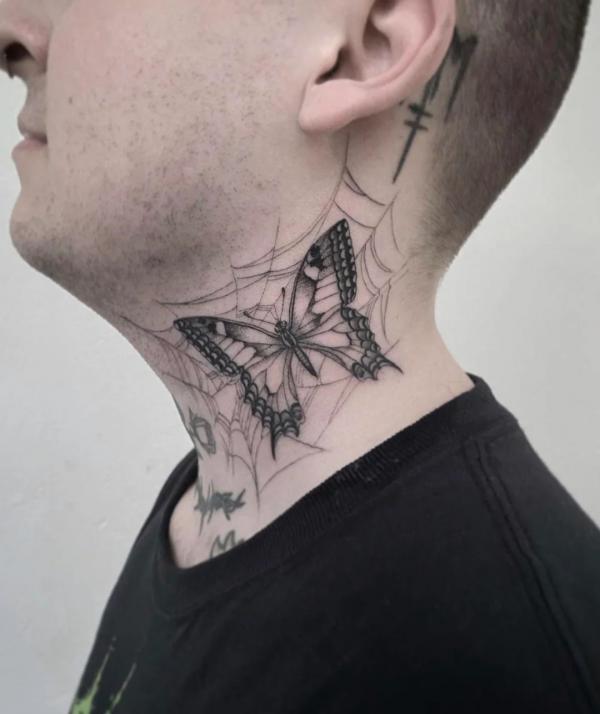 Butterfly with spider web tattoo on side of neck