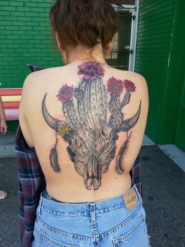 Cactus growing out of bull skull back tattoo