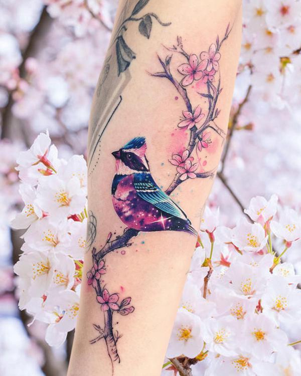 Cherry blossom and galaxy sparrow tattoo