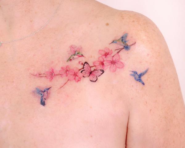 Cherry blossom surrounded by butterfly and hummingbirds