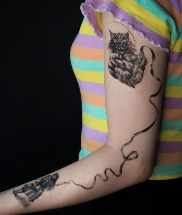 Cheshire Cat and Alick holding the two ends of ribbon