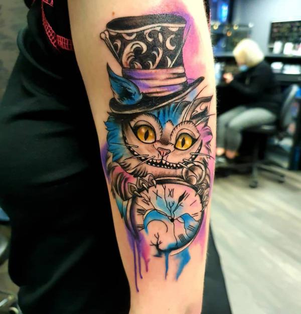 Cheshire Cat and clock tattoo