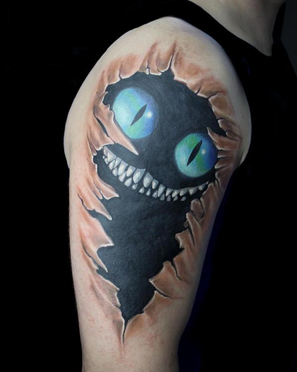 Cheshire Cat in ripped skin quarter sleeve tattoo